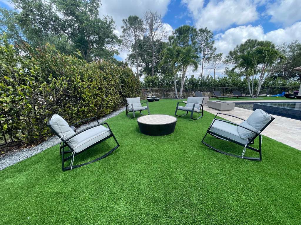 Beautiful patio with artificial grass by PortTowers
